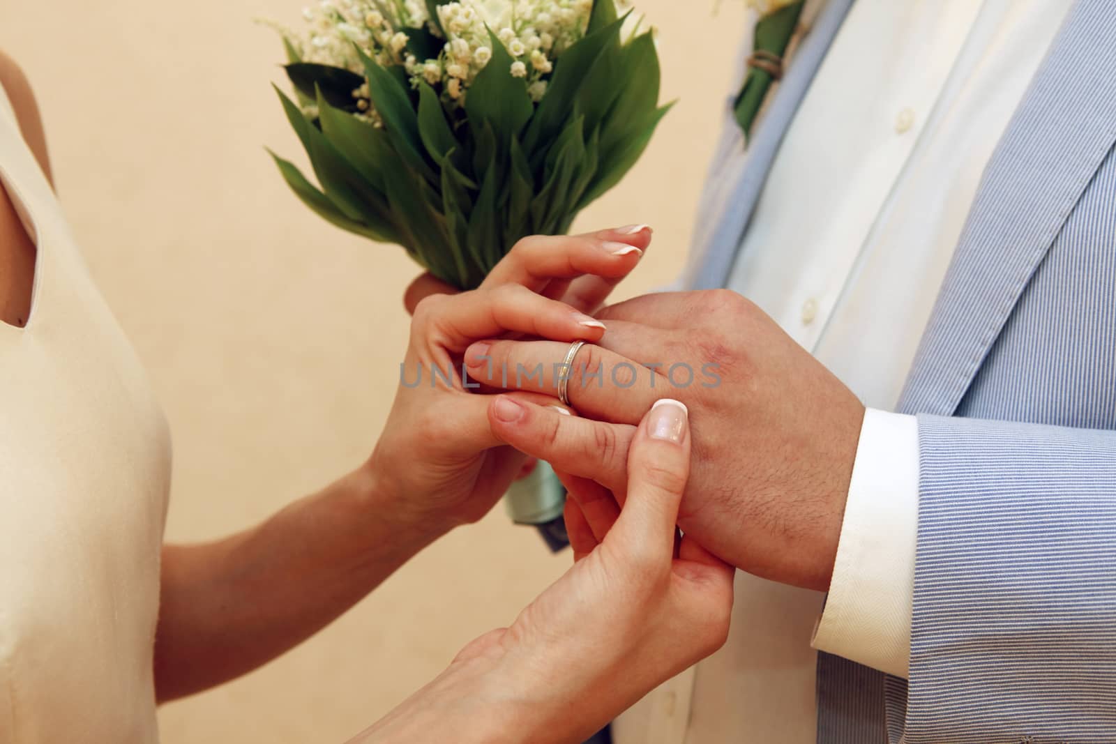 Bride wears a wedding ring to the groom