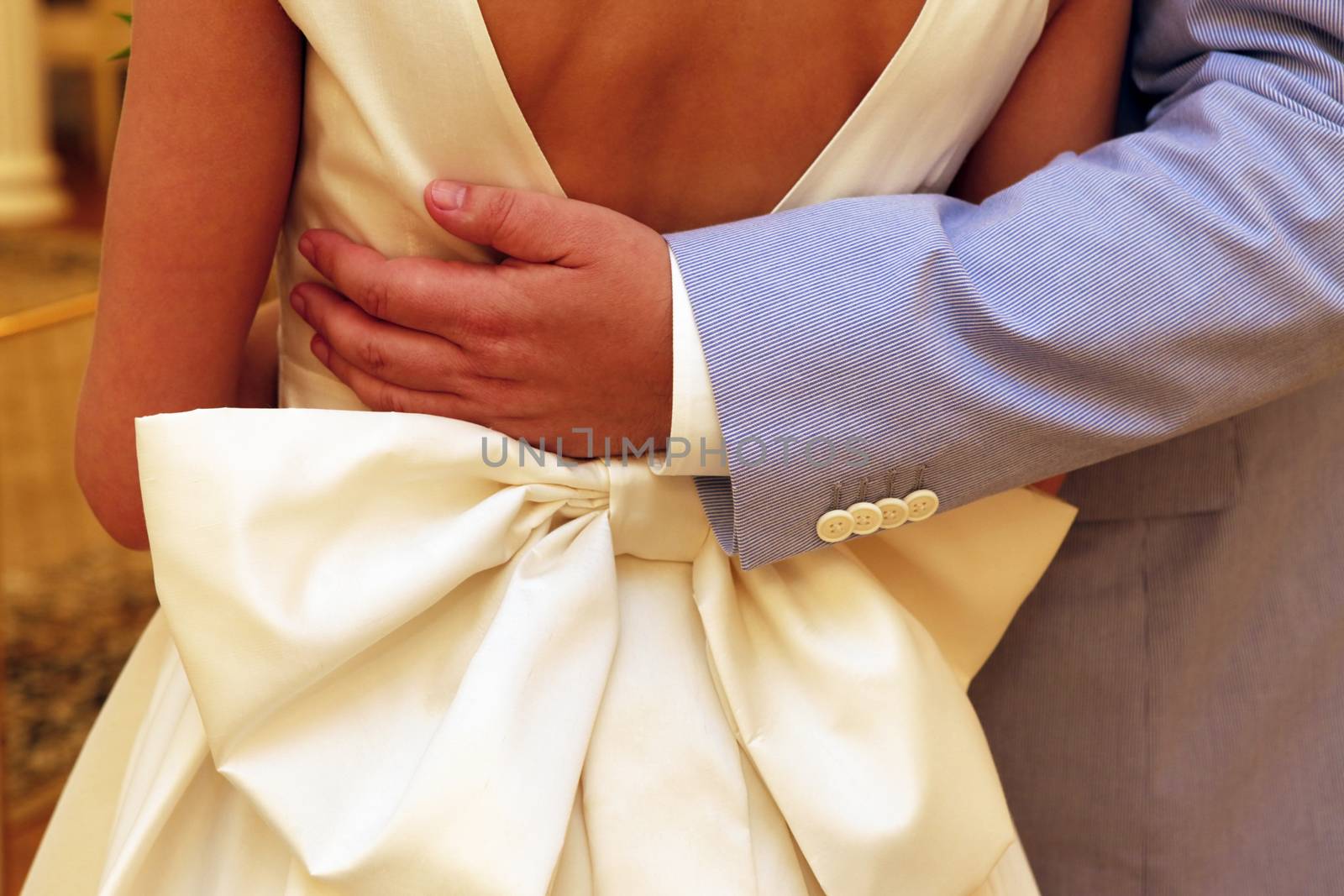Groom embracing his bride