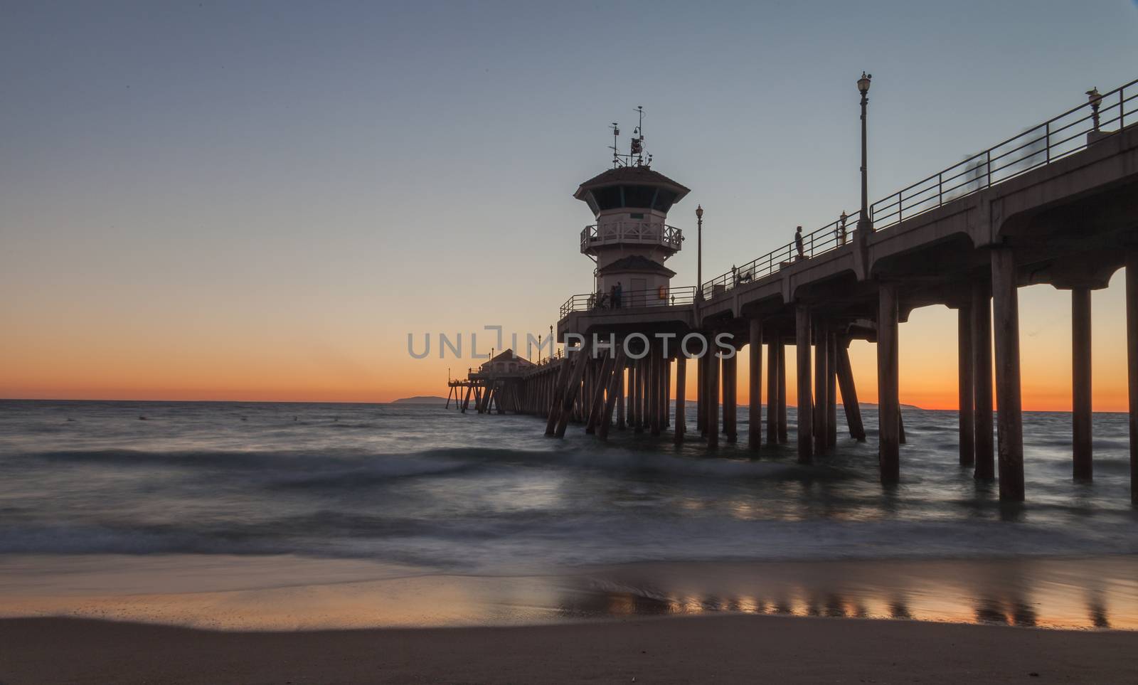 Under the Huntington Beach Pier in Huntington Beach, California, United States at sunset in the fall
