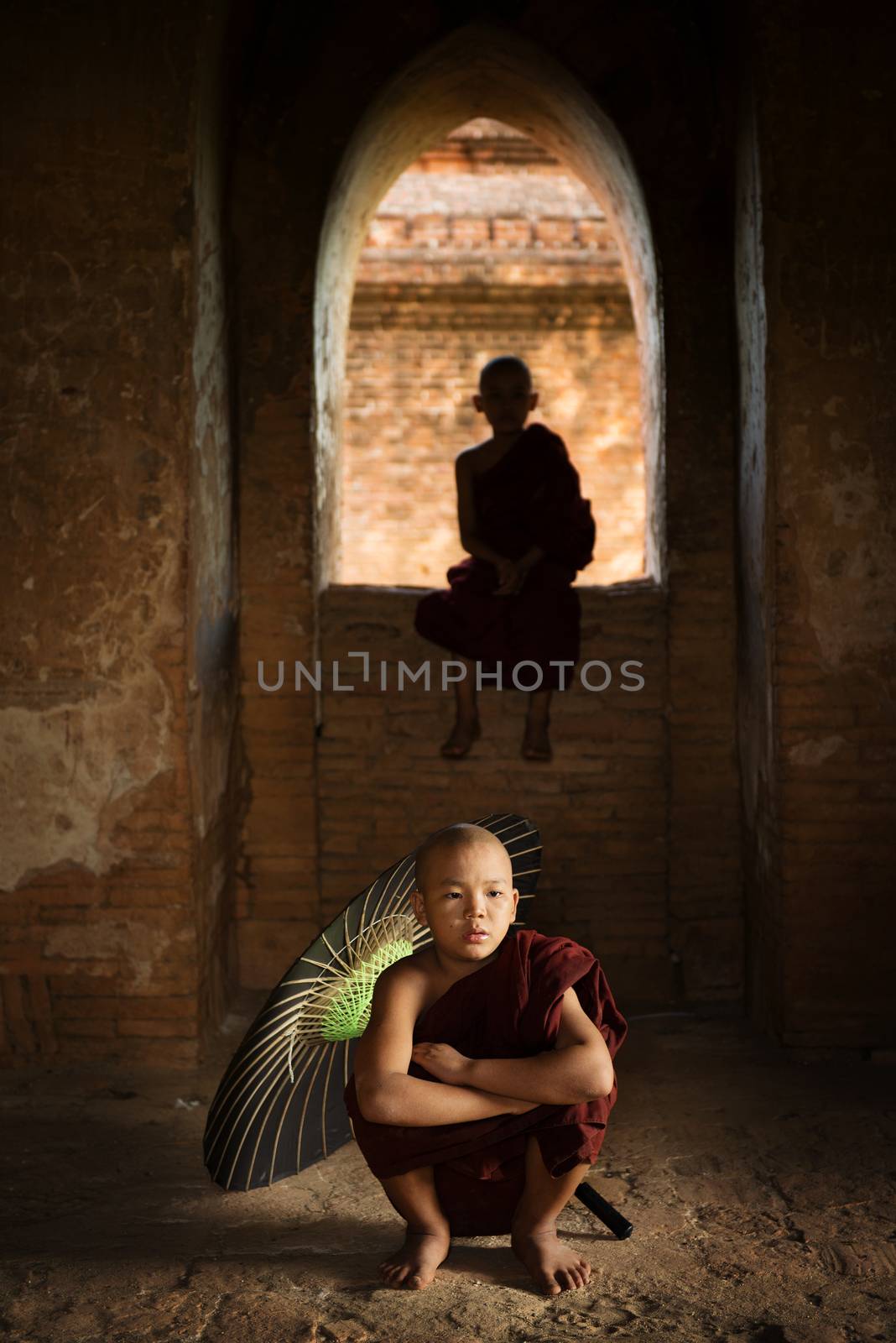 Portrait of young novice monks inside ancient Buddhist temple, Bagan, Myanmar.