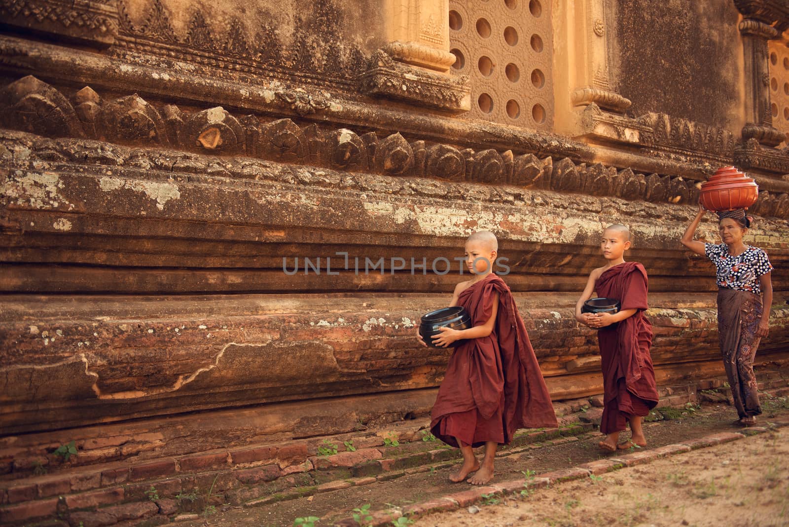 Buddhist novice monks walking alms in Bagan by szefei