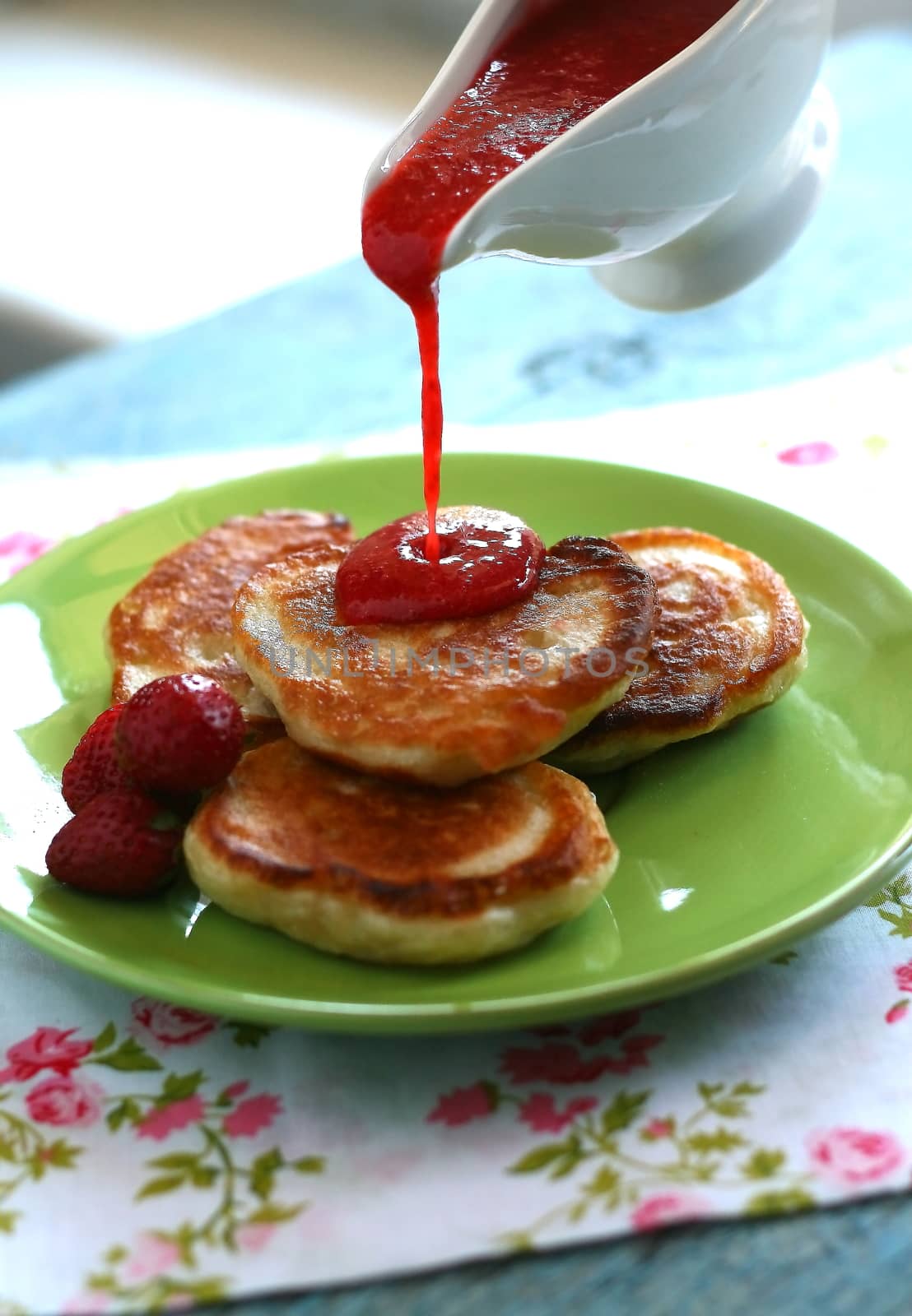 Breakfast serving of pancakes with strawberries and strawberry sauce in a pot in the style of a romantic