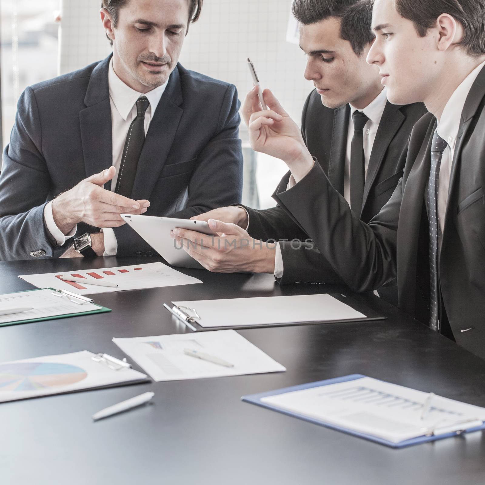 Business people discussing charts  by ALotOfPeople