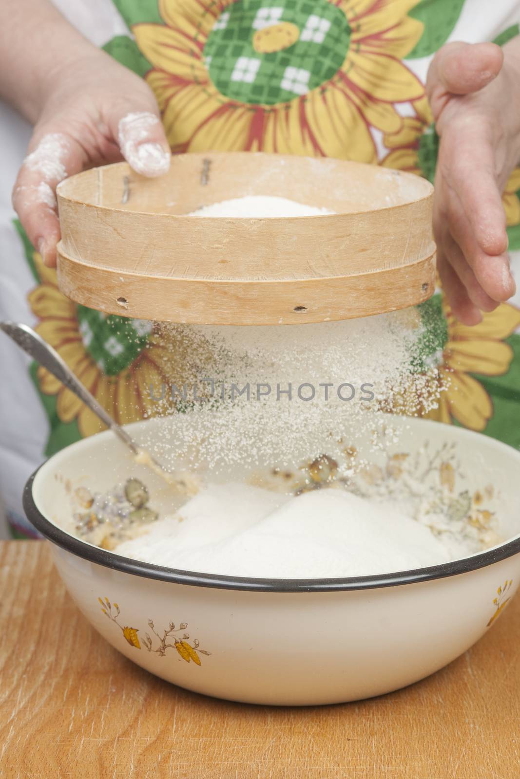 Women's hands preparing flour before baking pie.
