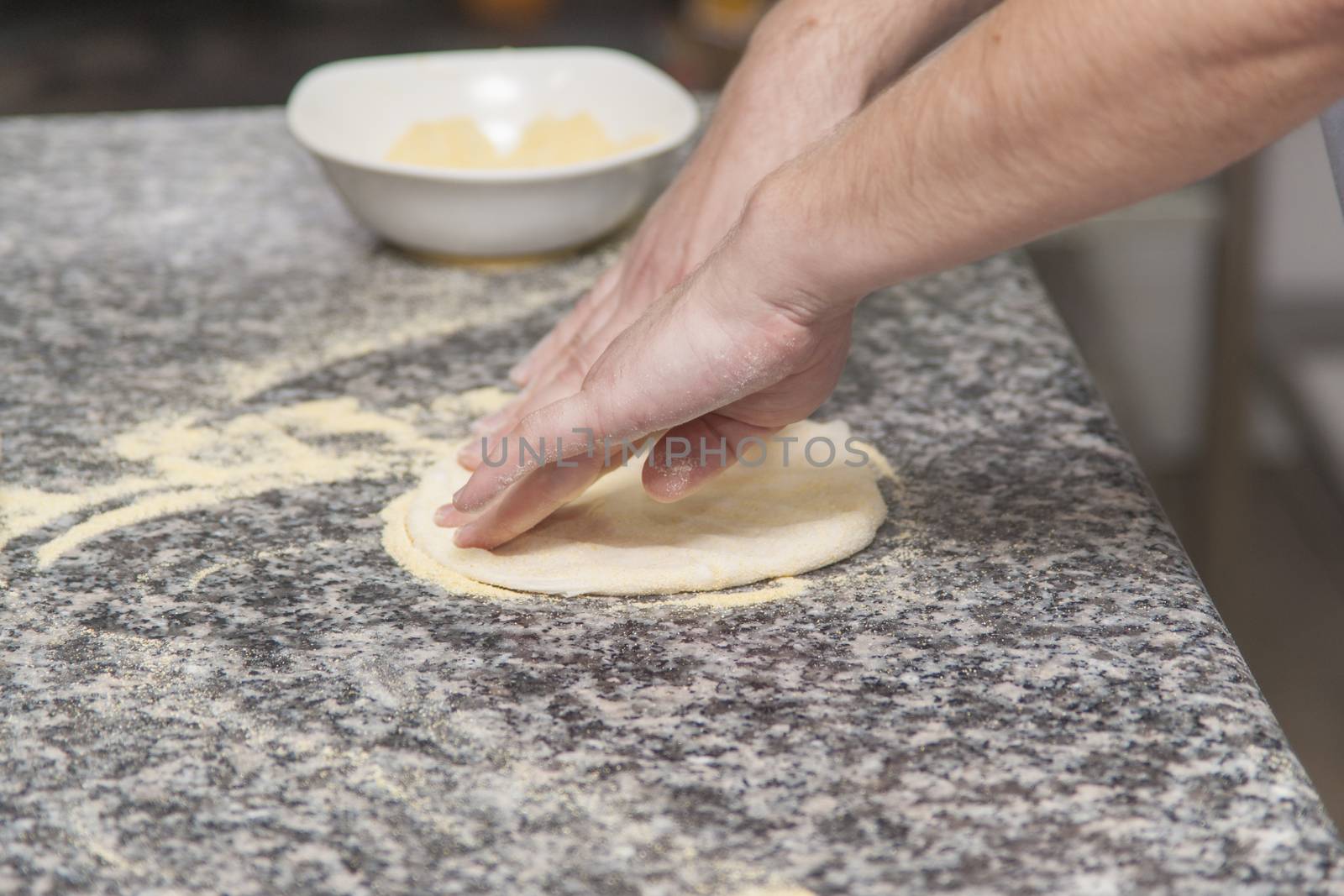 Woman chef with raw dough. Young female in uniform preparing bread dough on table.