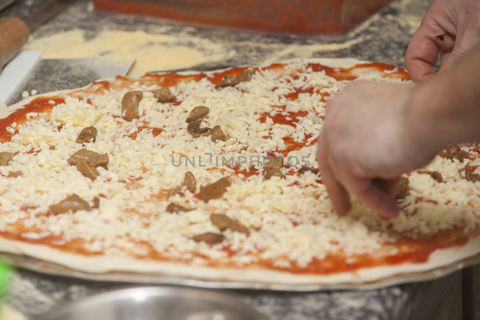 Man chef with raw pizza. by kozak