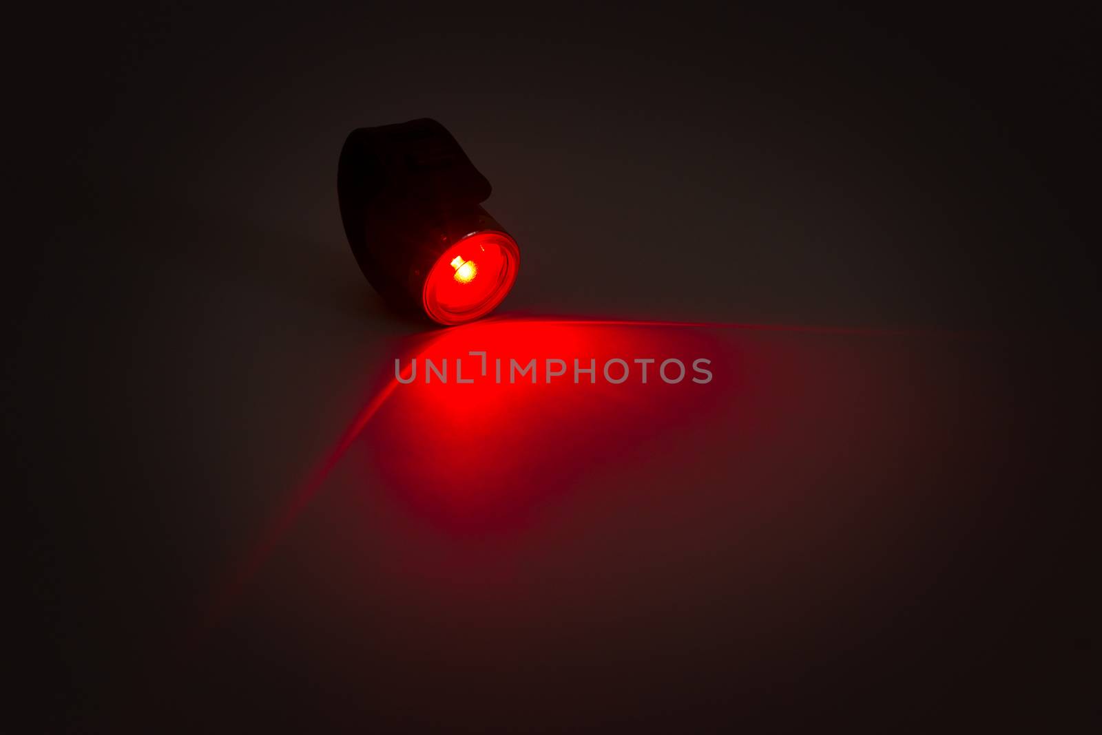 Color shot of a red light on the tail on grey background by DNKSTUDIO