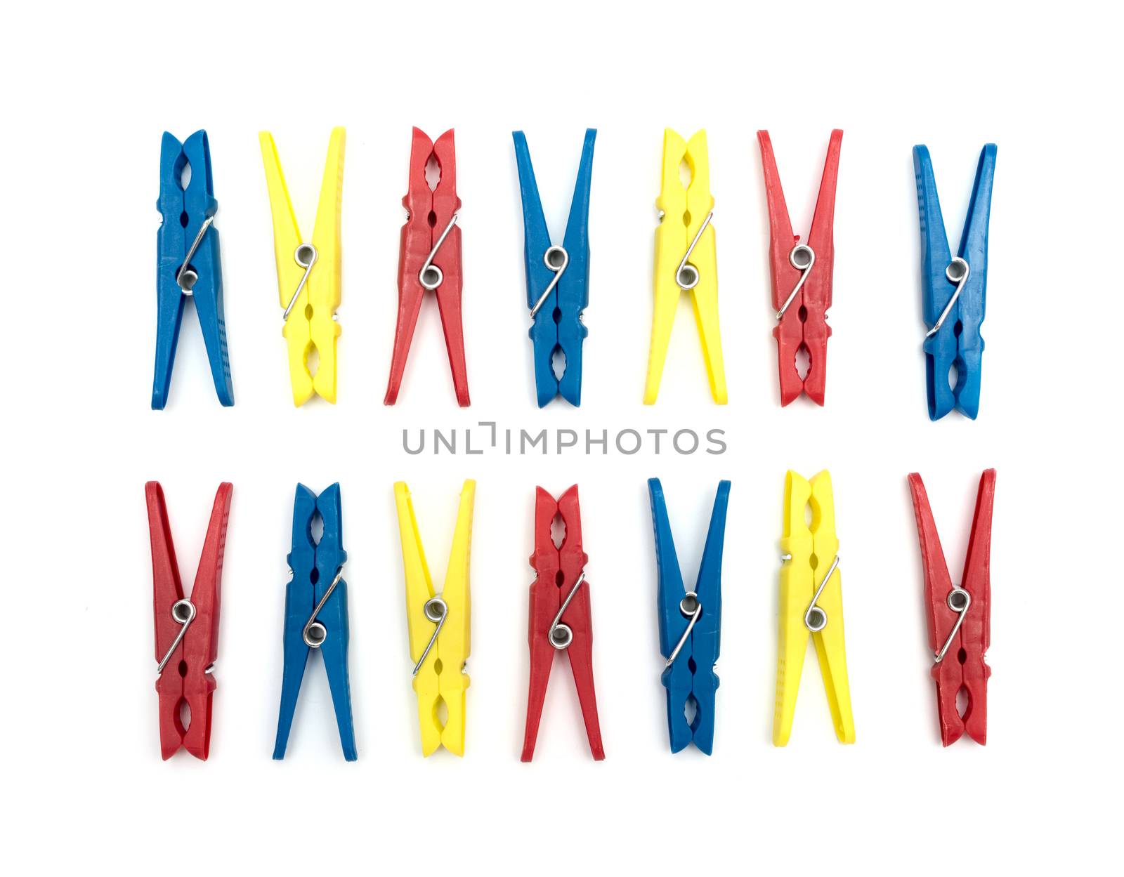 Multicoloured plastic clothes pegs on a white background by DNKSTUDIO