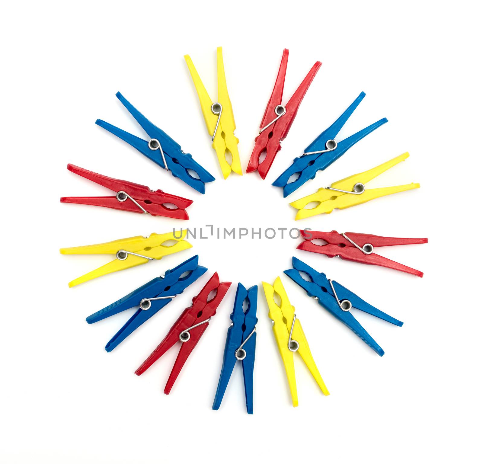 Multicoloured plastic clothes pegs on a white background