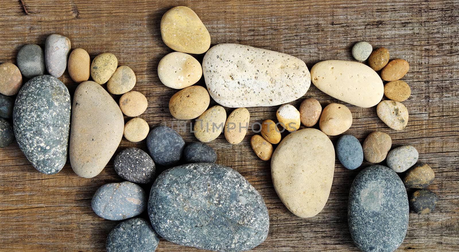 Abstract cute concept on wood background from pebbles, amazing arranged boulder to family of footprint, awesome shape from pebblestone