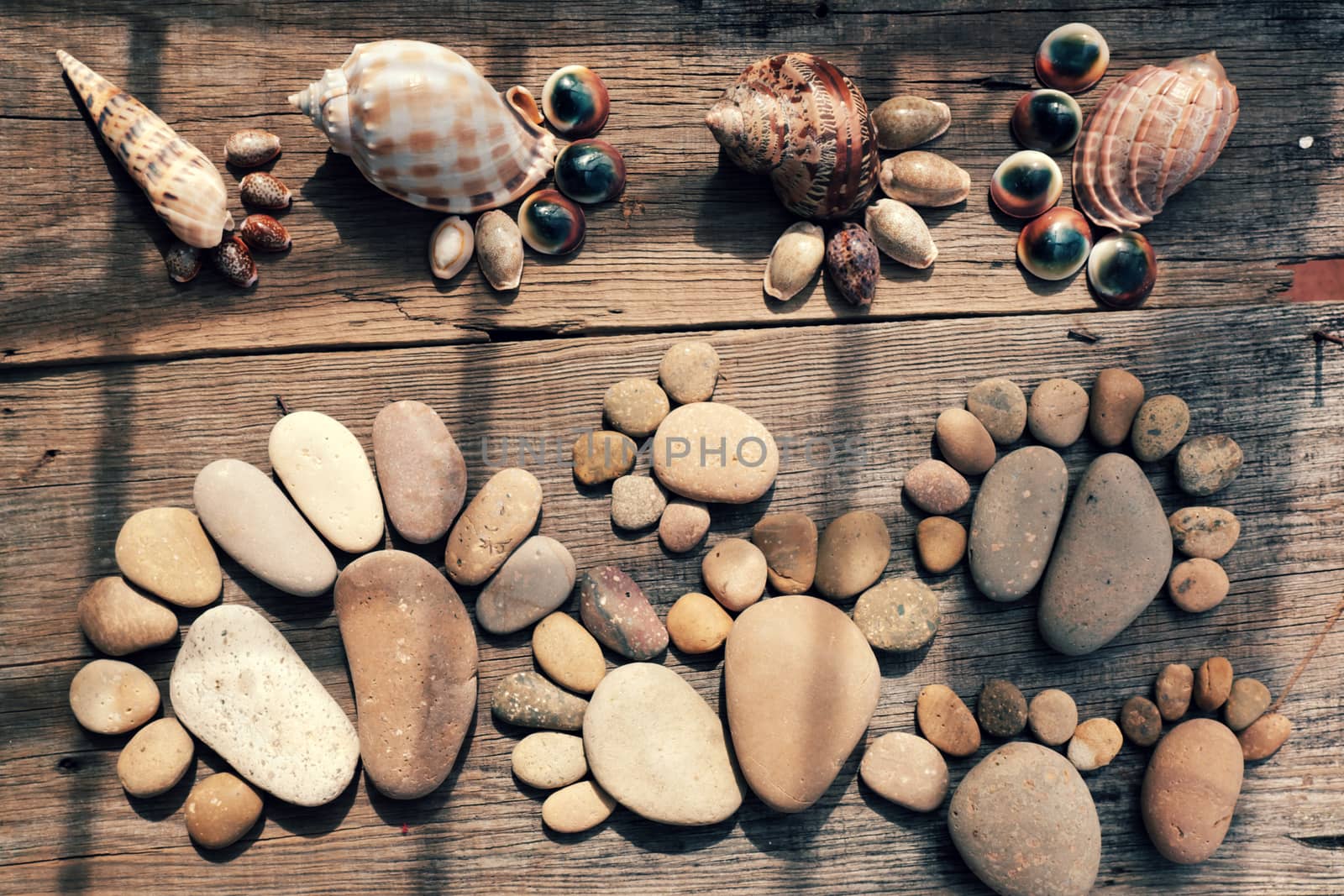 Abstract cute concept on wood background from pebbles, amazing arranged boulder to family of footprint, awesome shape from pebblestone