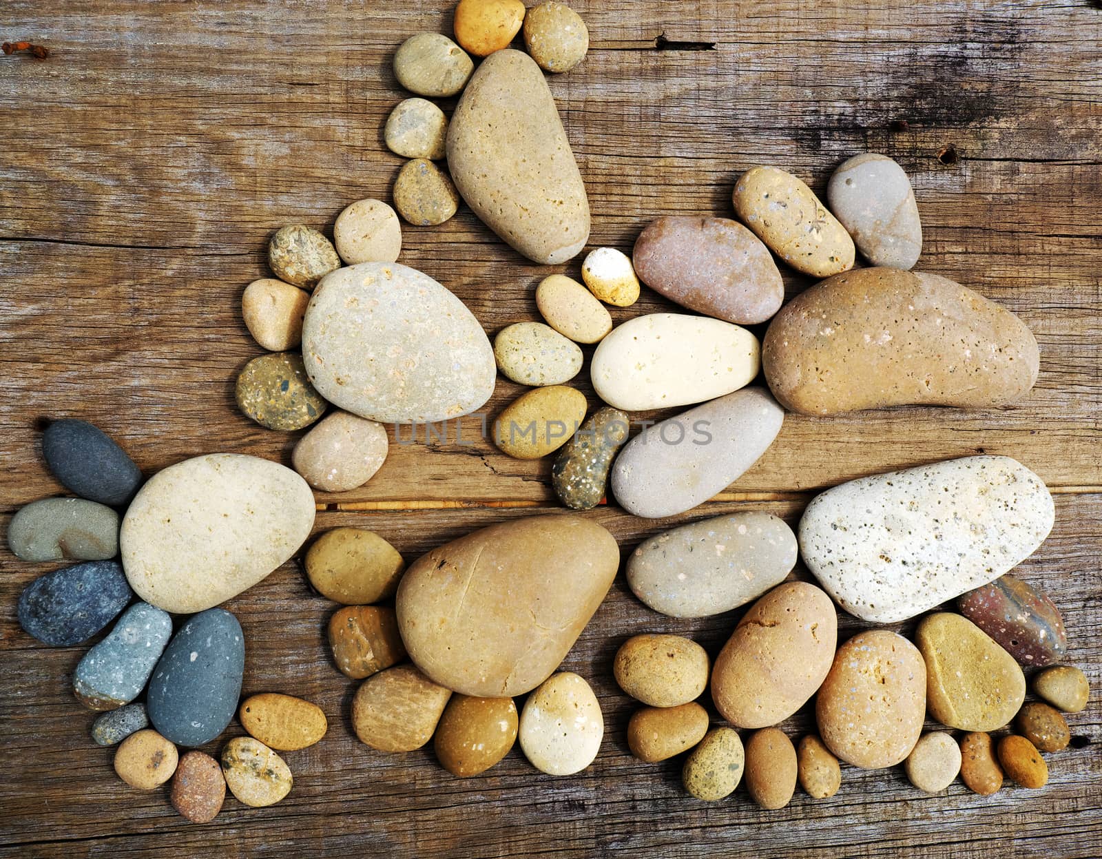 Abstract cute concept on wood background from pebbles, amazing arranged boulder to family of footprint, awesome shape from pebblestone