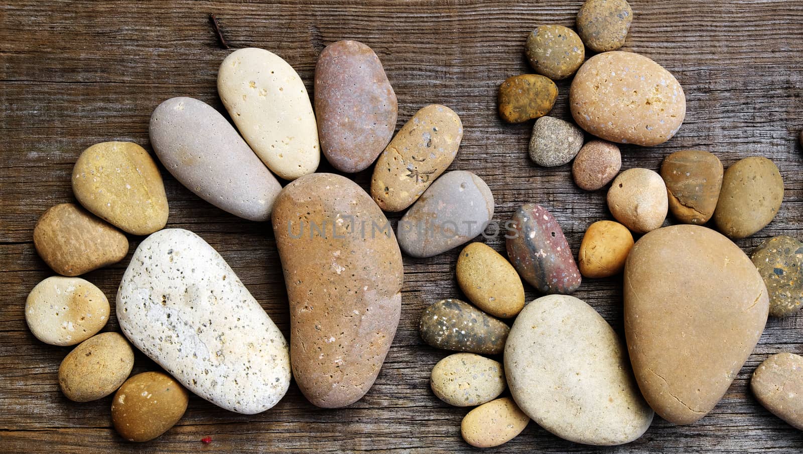 Abstract cute concept on wood background from pebbles, amazing arranged boulder to family of footprint, awesome shape from pebblestone