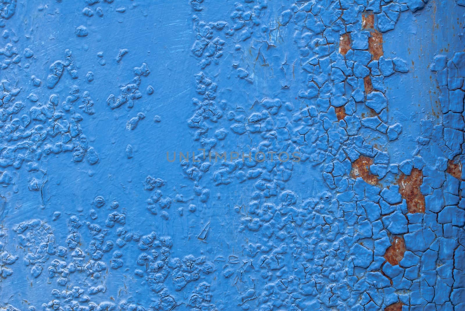 fragment of an iron surface is covered with blue color paint, which has long been under the influence of different climatic conditions