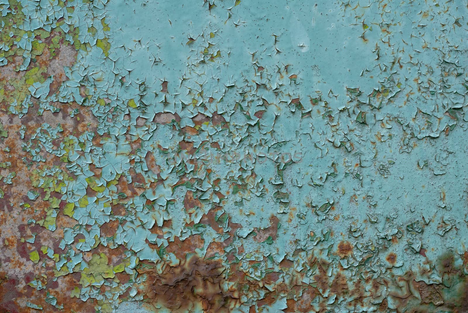 rusty iron surface covered with old chipped emerald color paint, which has long been influenced by different climatic conditions