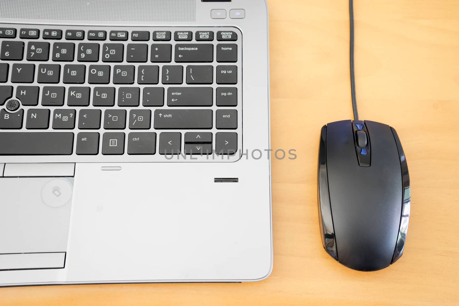 keyboard and mouse on wooden table