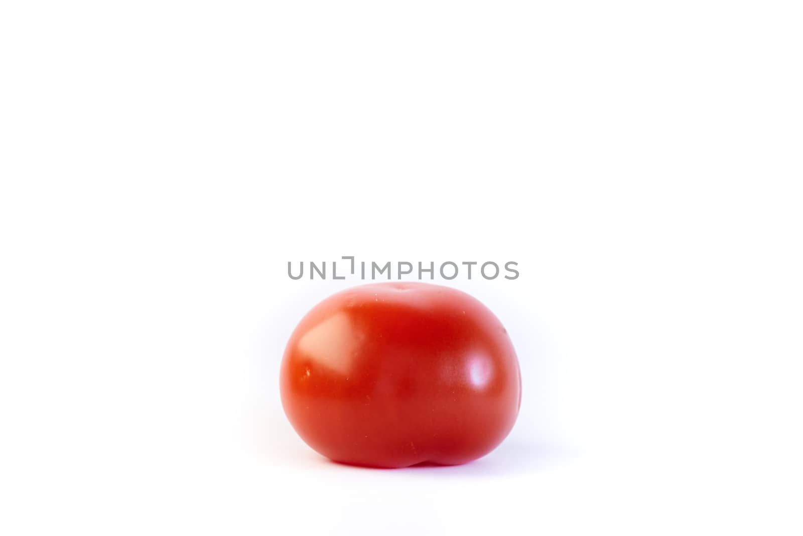Plain red standard tomato isolated on white.
