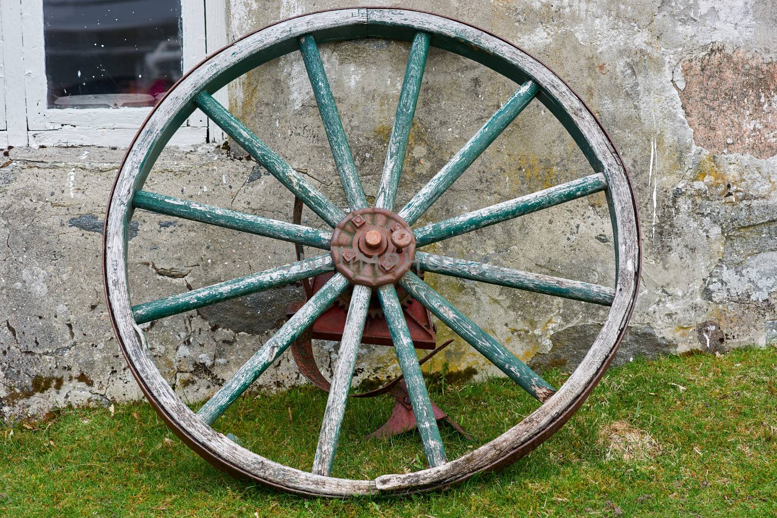 Closeup of wooden wheel with metal parts.