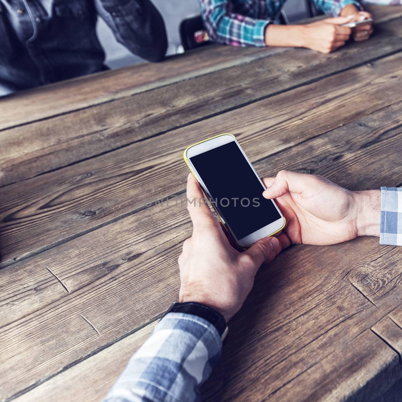 Detail of hipster modern business people using smart phone in loft office