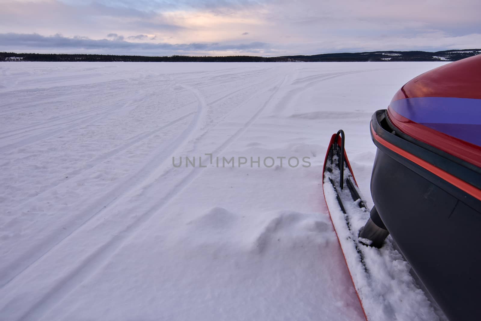 Ready to head over a frozen lake with snowmobile.