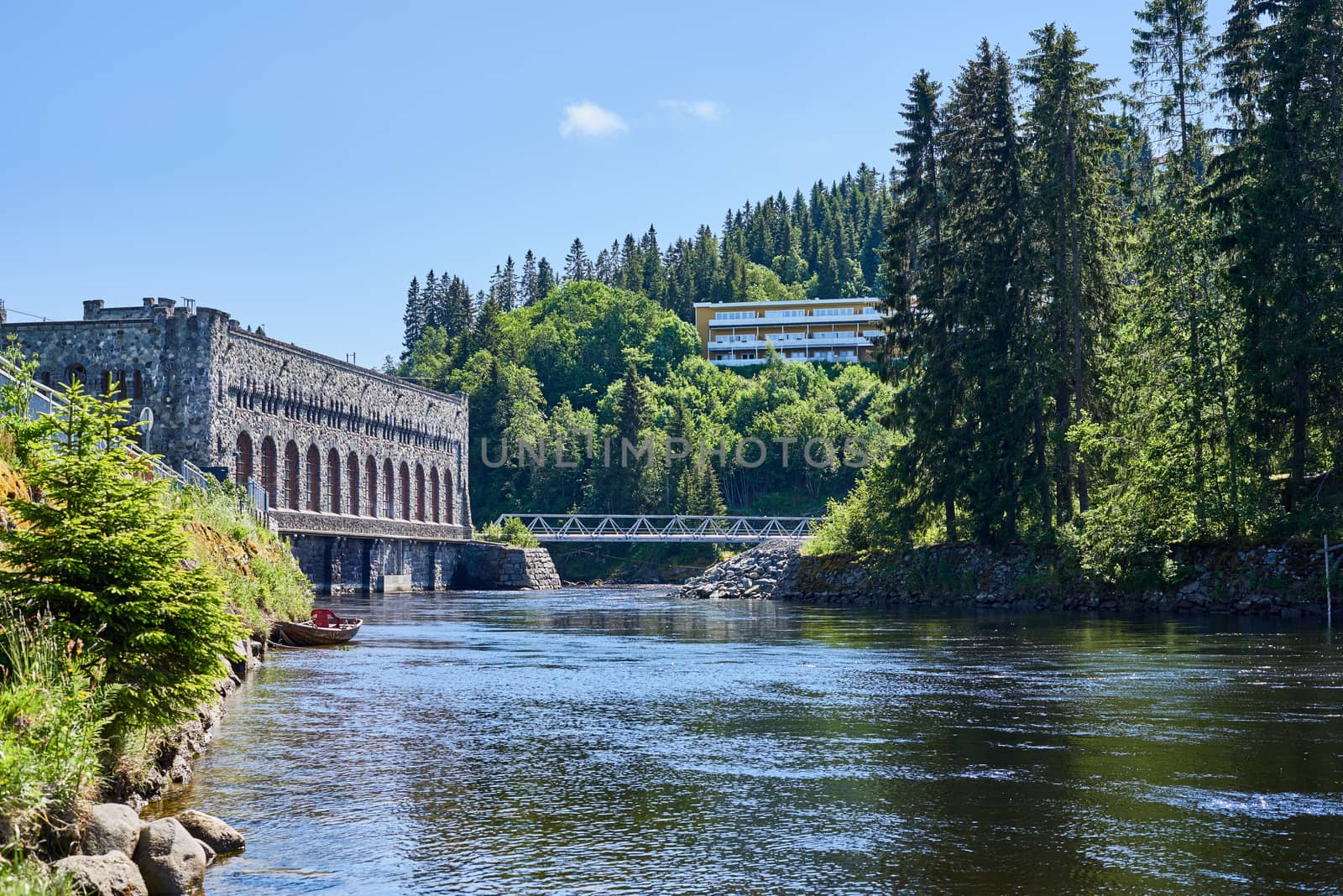 A river beneath a hydroelectric power plant building.
