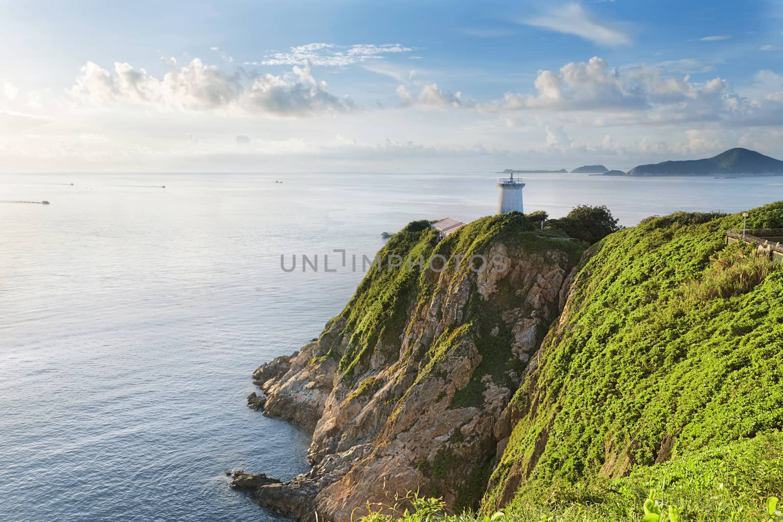 Hong Kong lighthouse during sunrise by cozyta