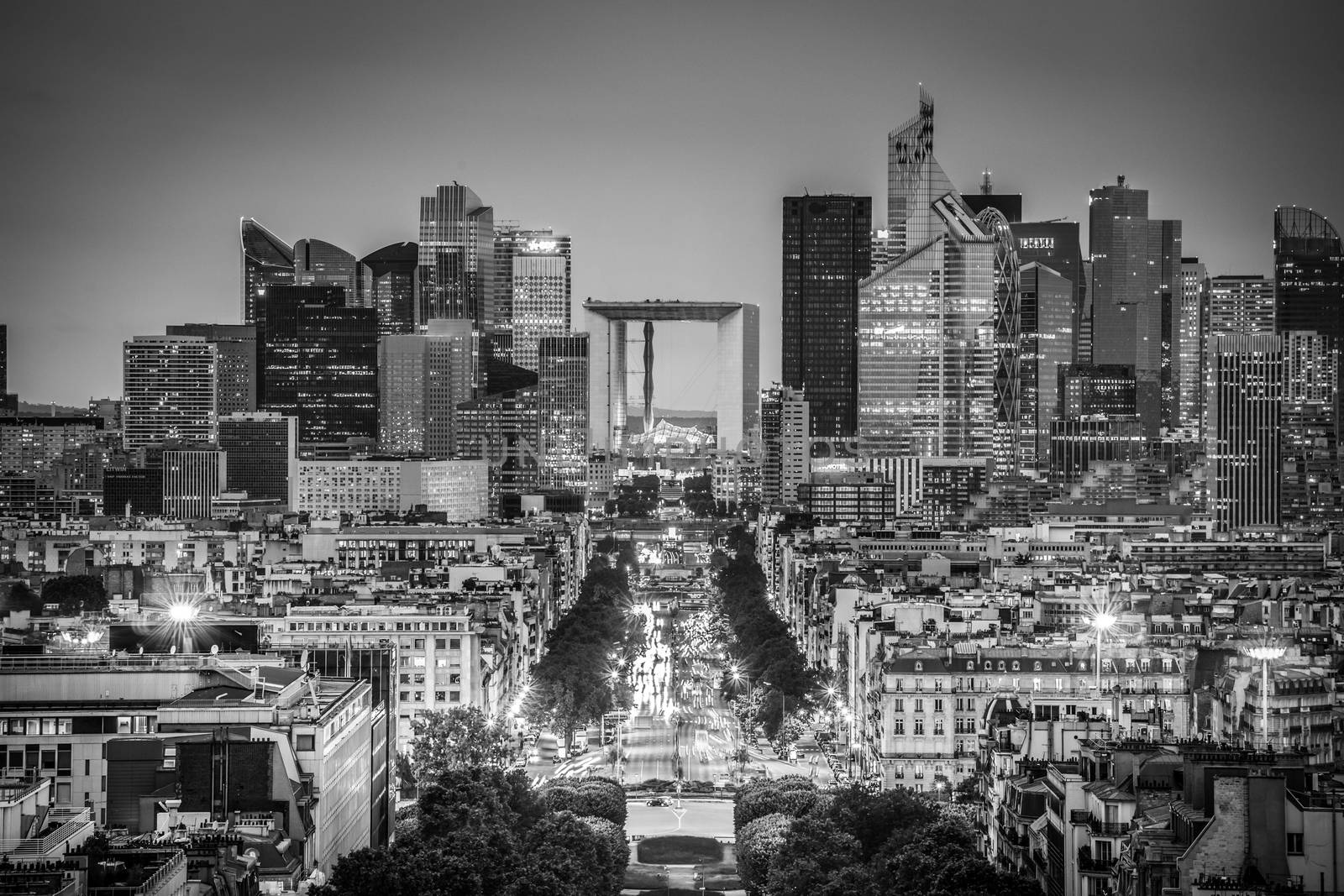 View of La Defence Paris business district from Place Charles De Gaulle at dusk. Black and white image.