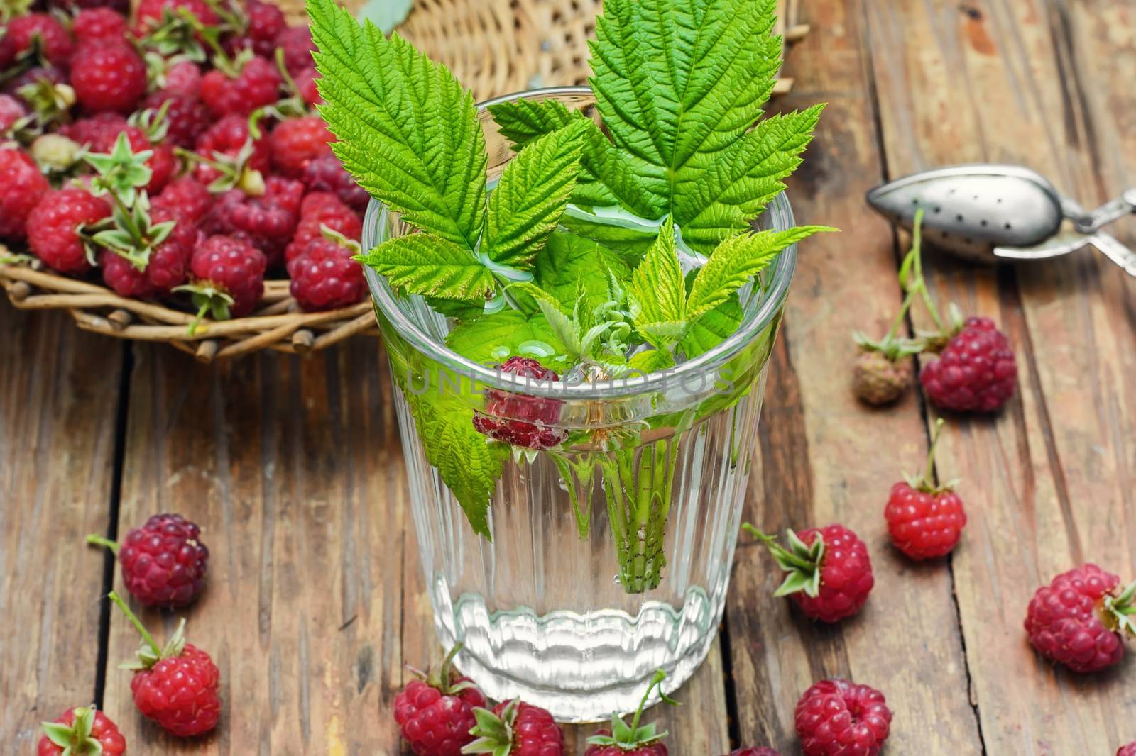 summer tea with fruits of raspberry in faceted glass