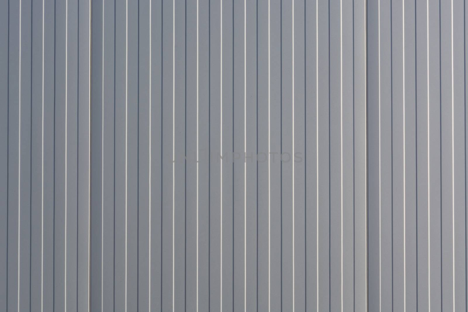Silver-colored metal wall corrugated sheet metal background.