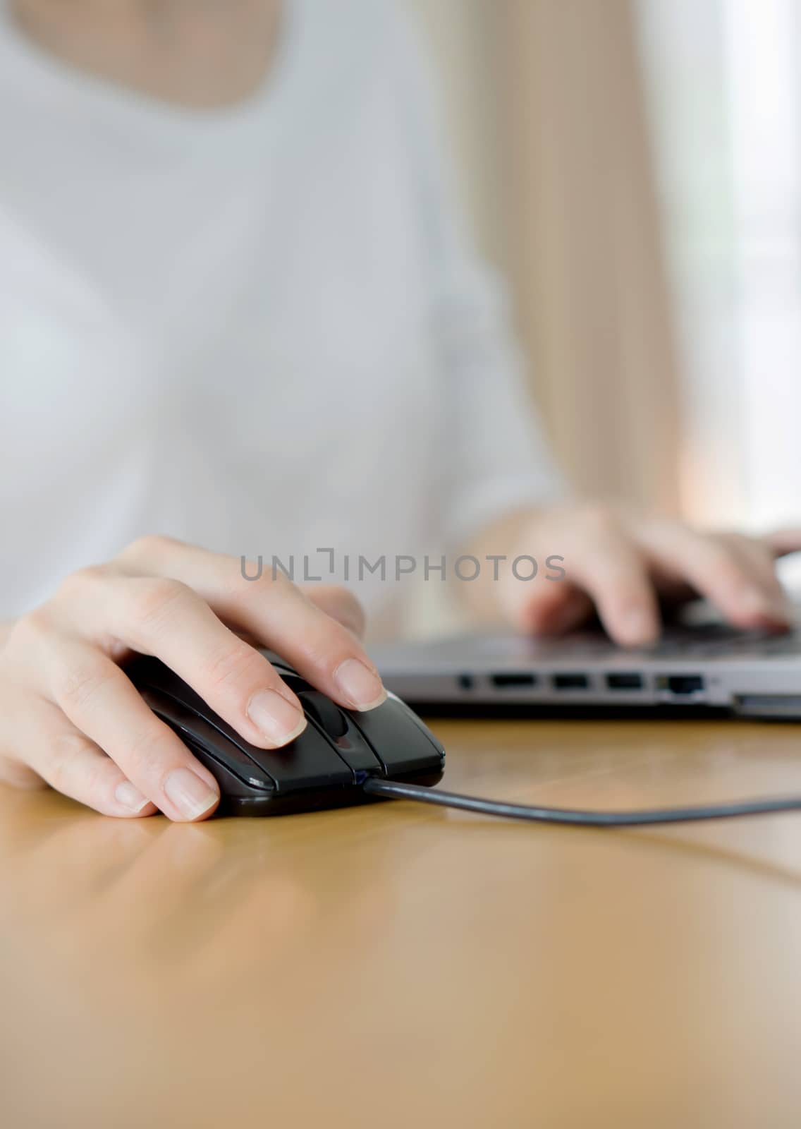 Female hand touching computer mouse closeup by ekachailo