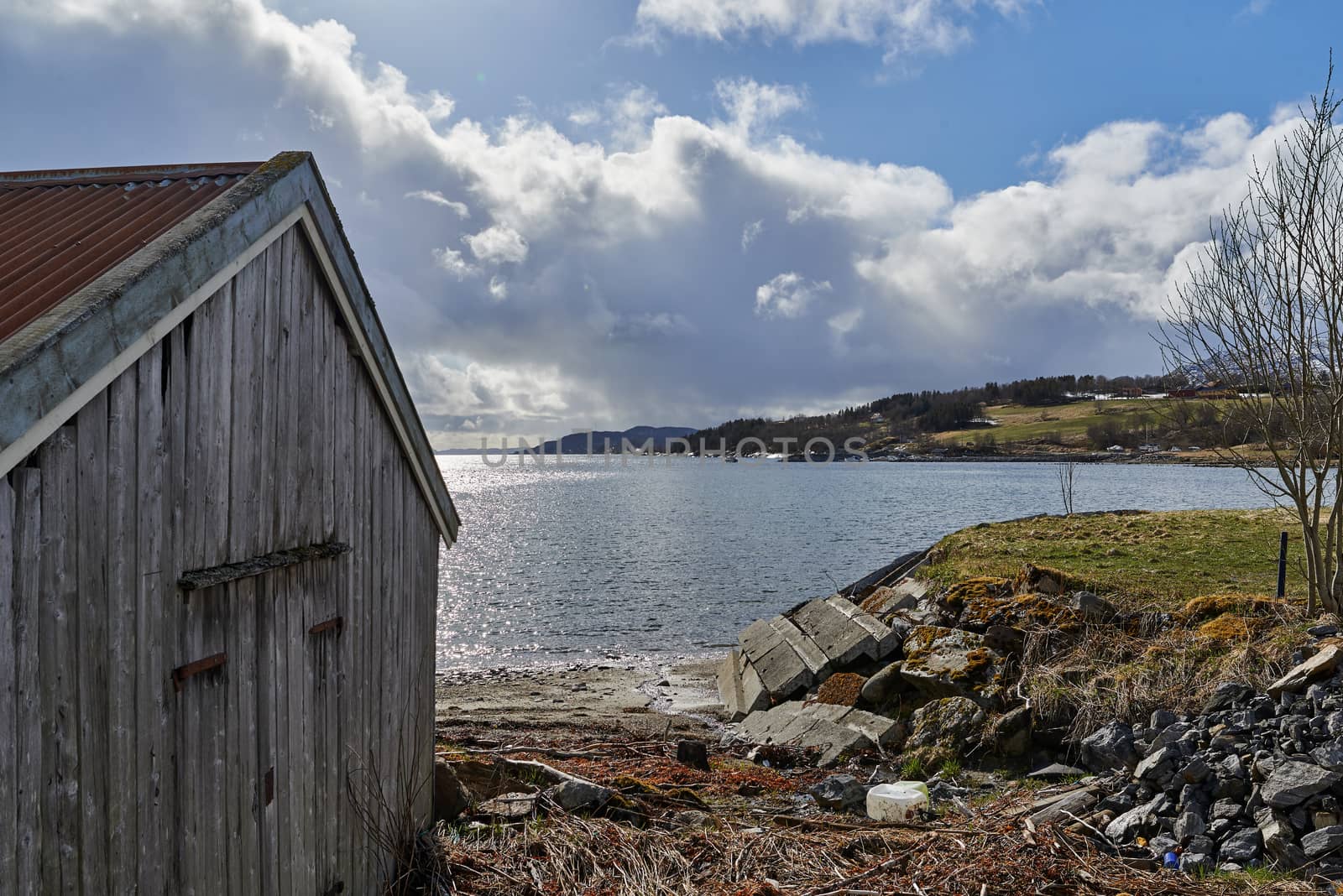 Old boathouse waiting for bad weather in the distance.