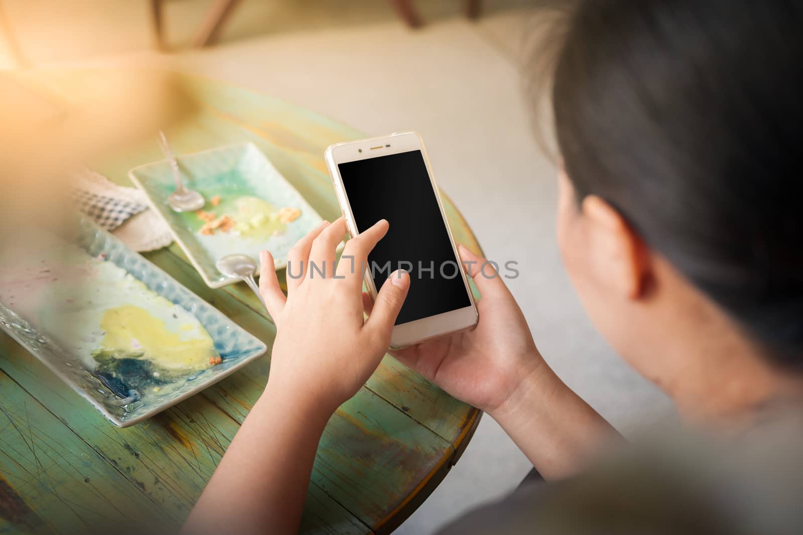 Young woman using smartphone for social networking in cafe on weekend. Trendy lifestyle concept with technology.