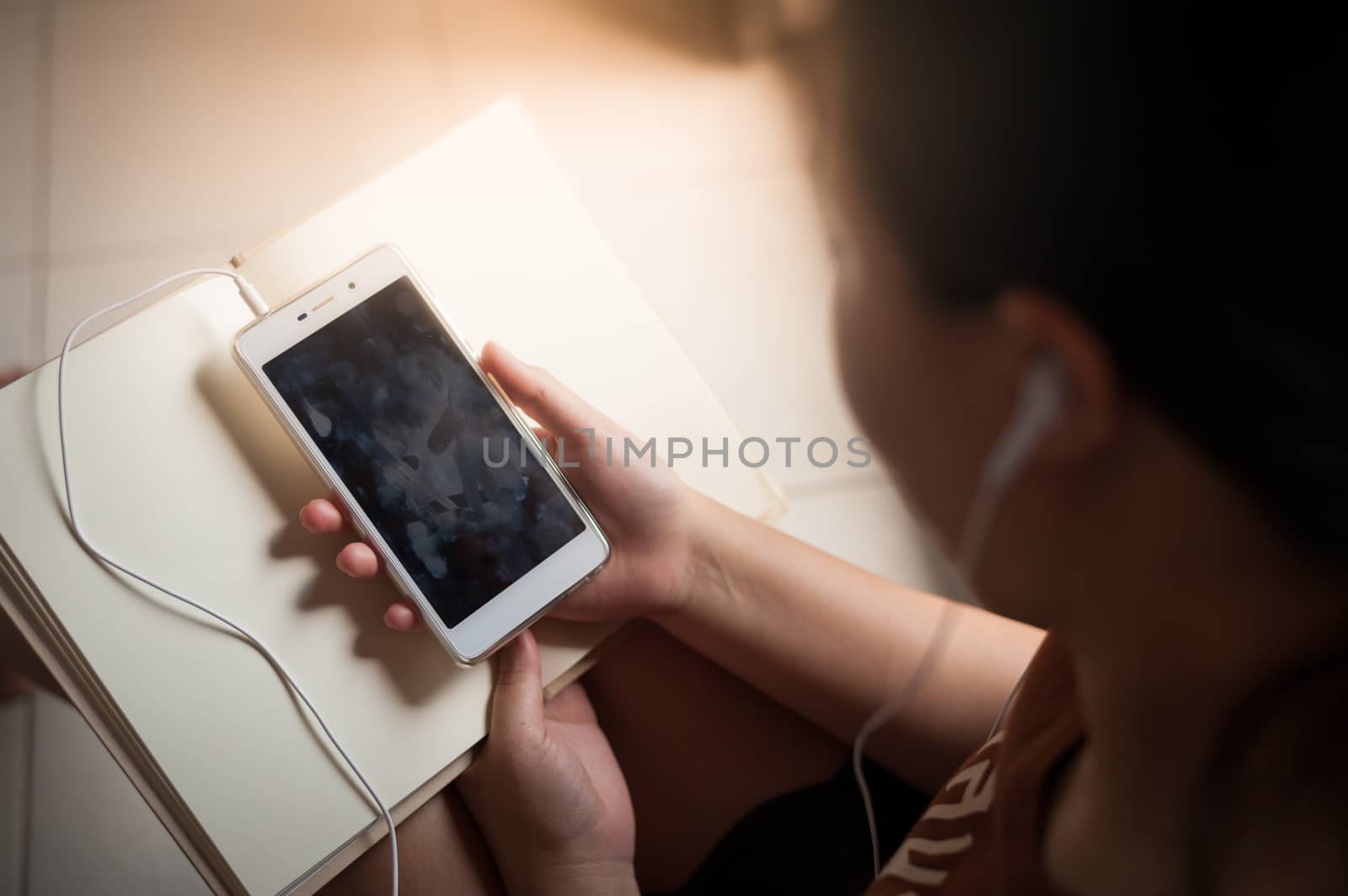 Woman using smartphone in cafe by silatip