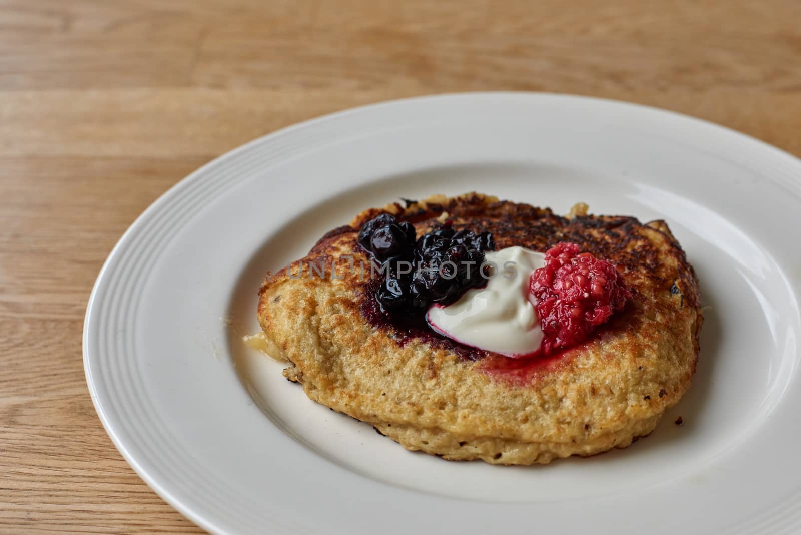 Pancake made from banana with homemade blueberry and raspberry jam