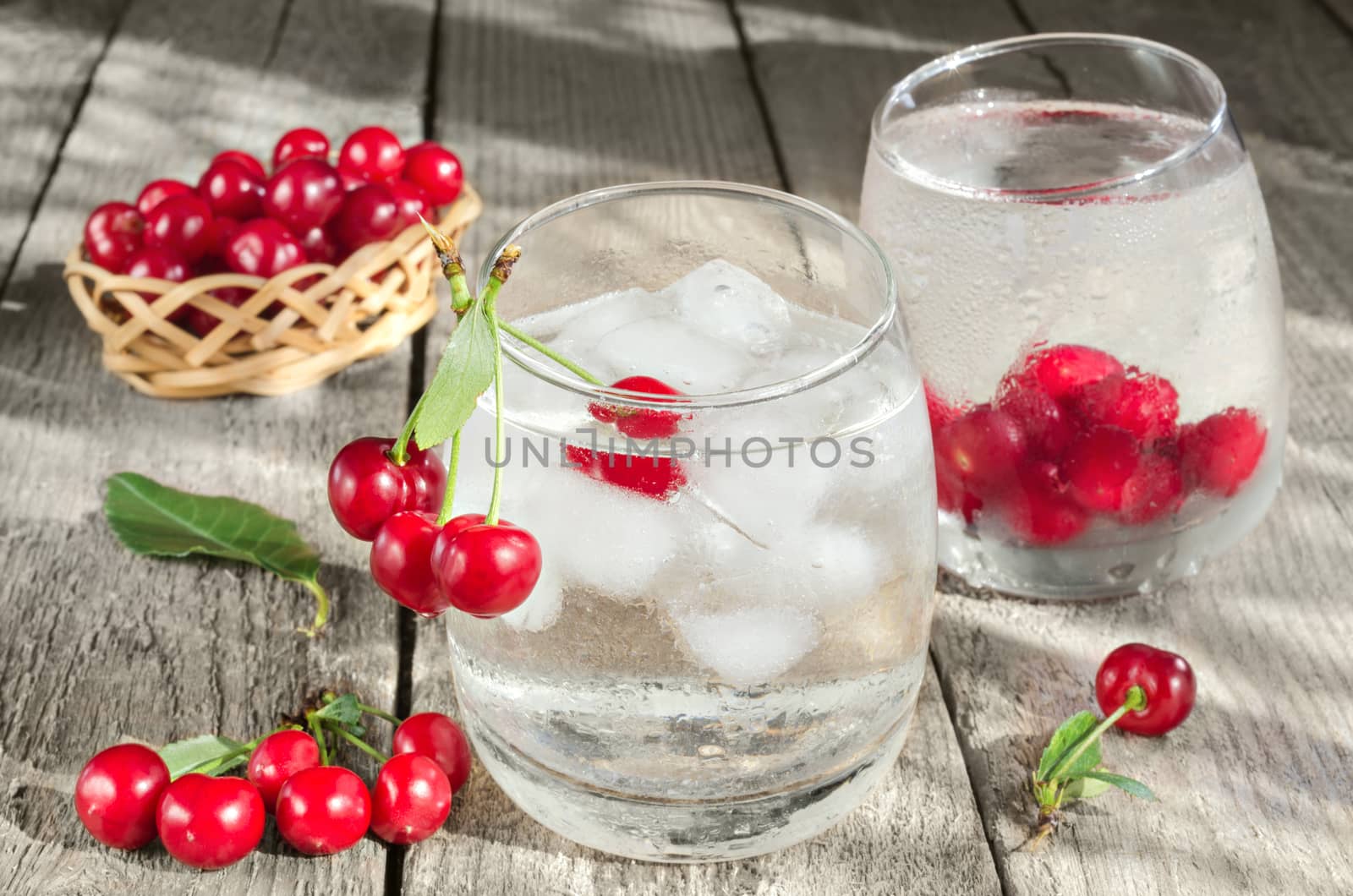 Mineral water with ice and cherries by Gaina
