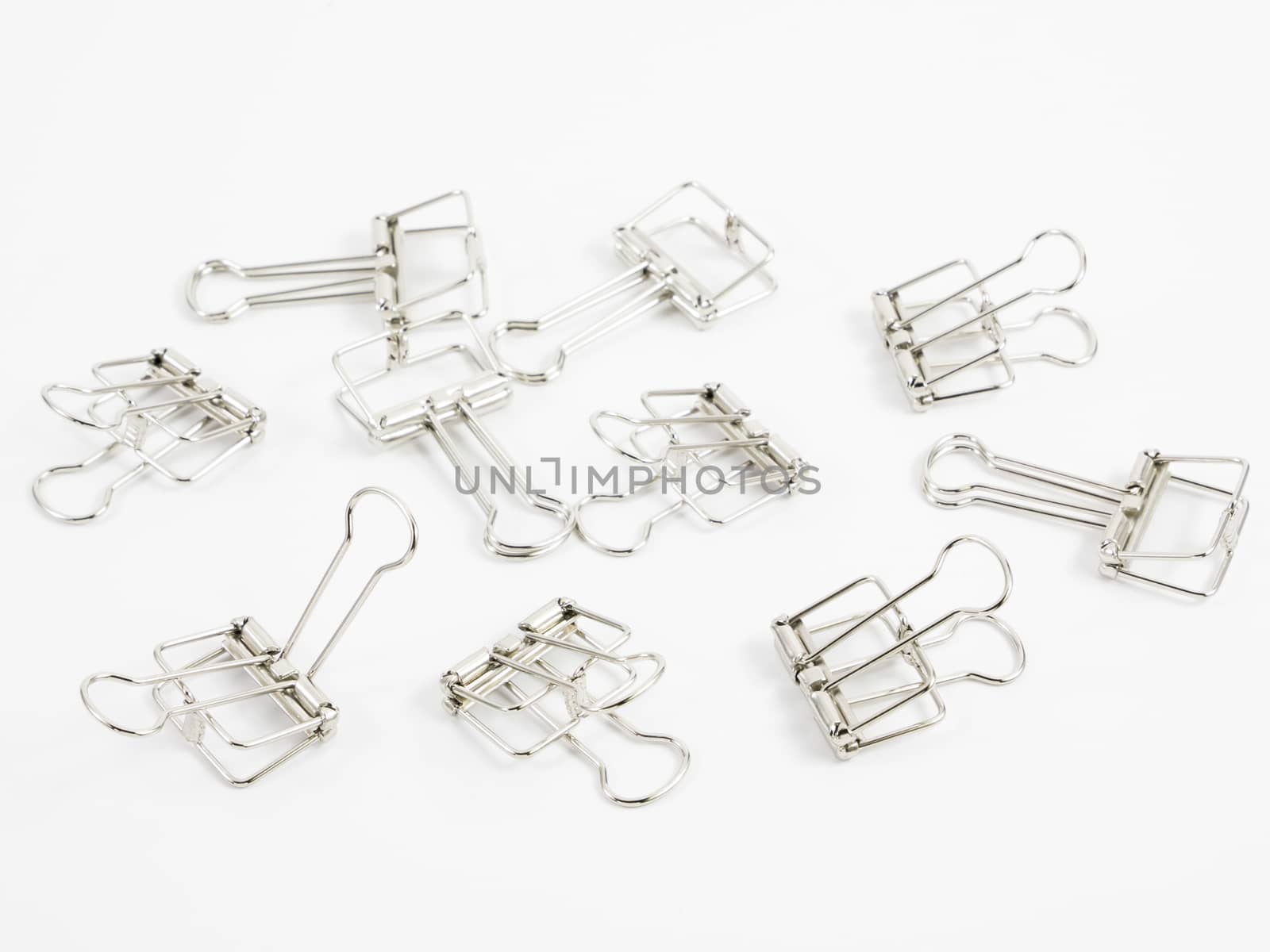 The silver binder clip (paper clip stationery).