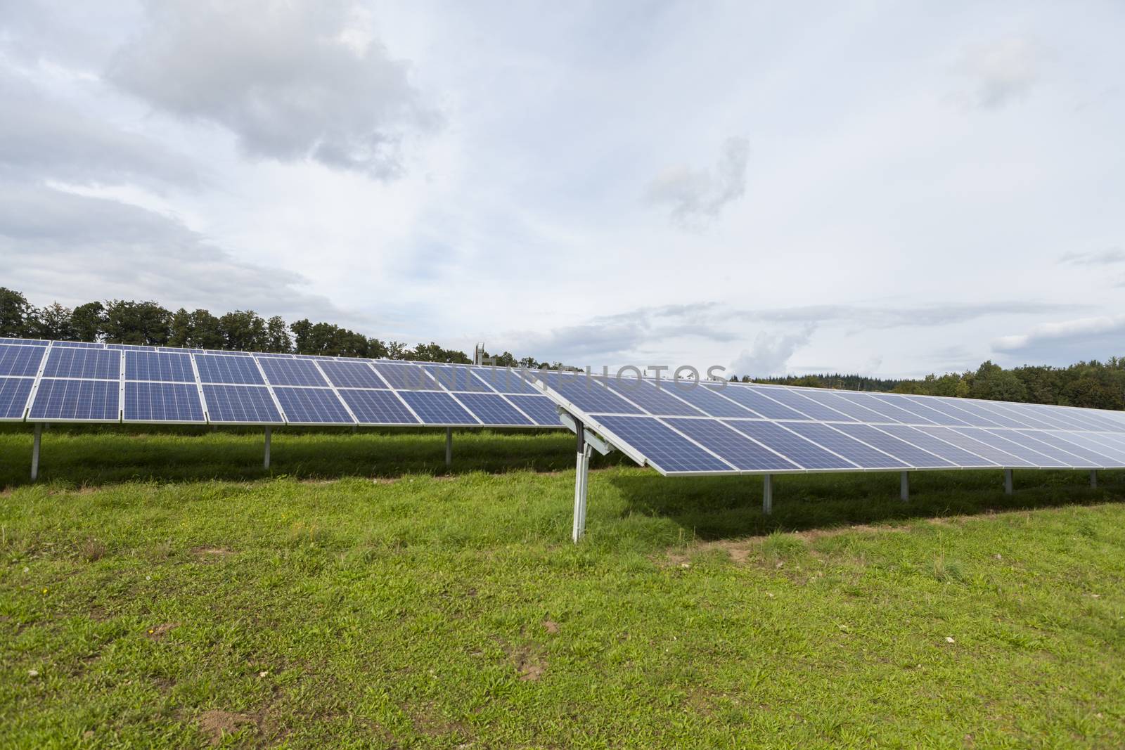 Field with blue siliciom solar cells alternative energy by juniart