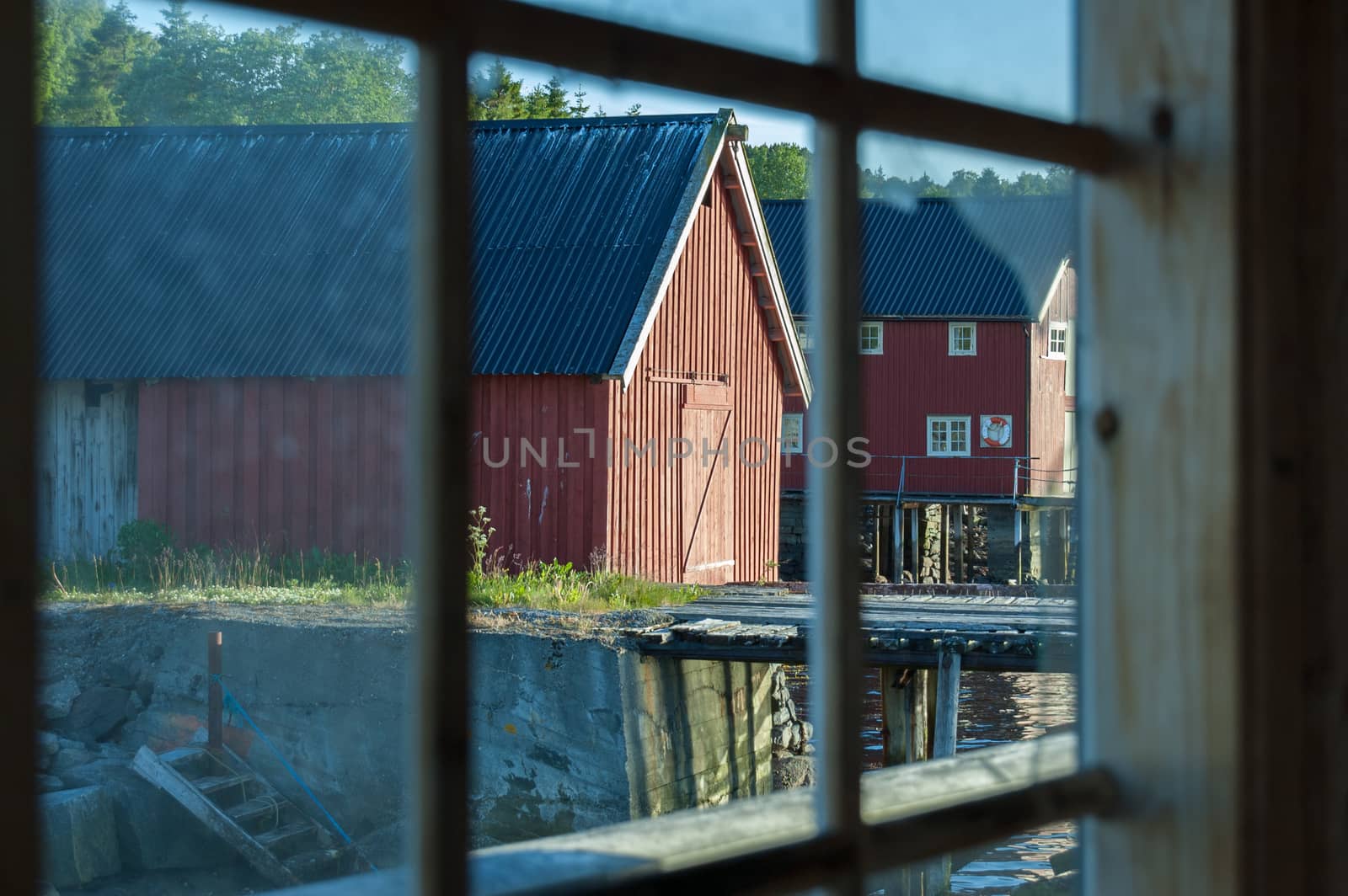 View of boathouses from a broken window.