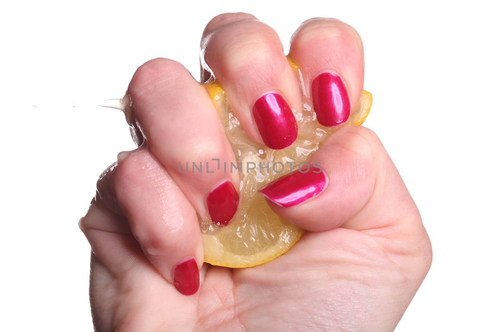 Hand with manicured nails painted a deep glossy red squeeze lemon on white background