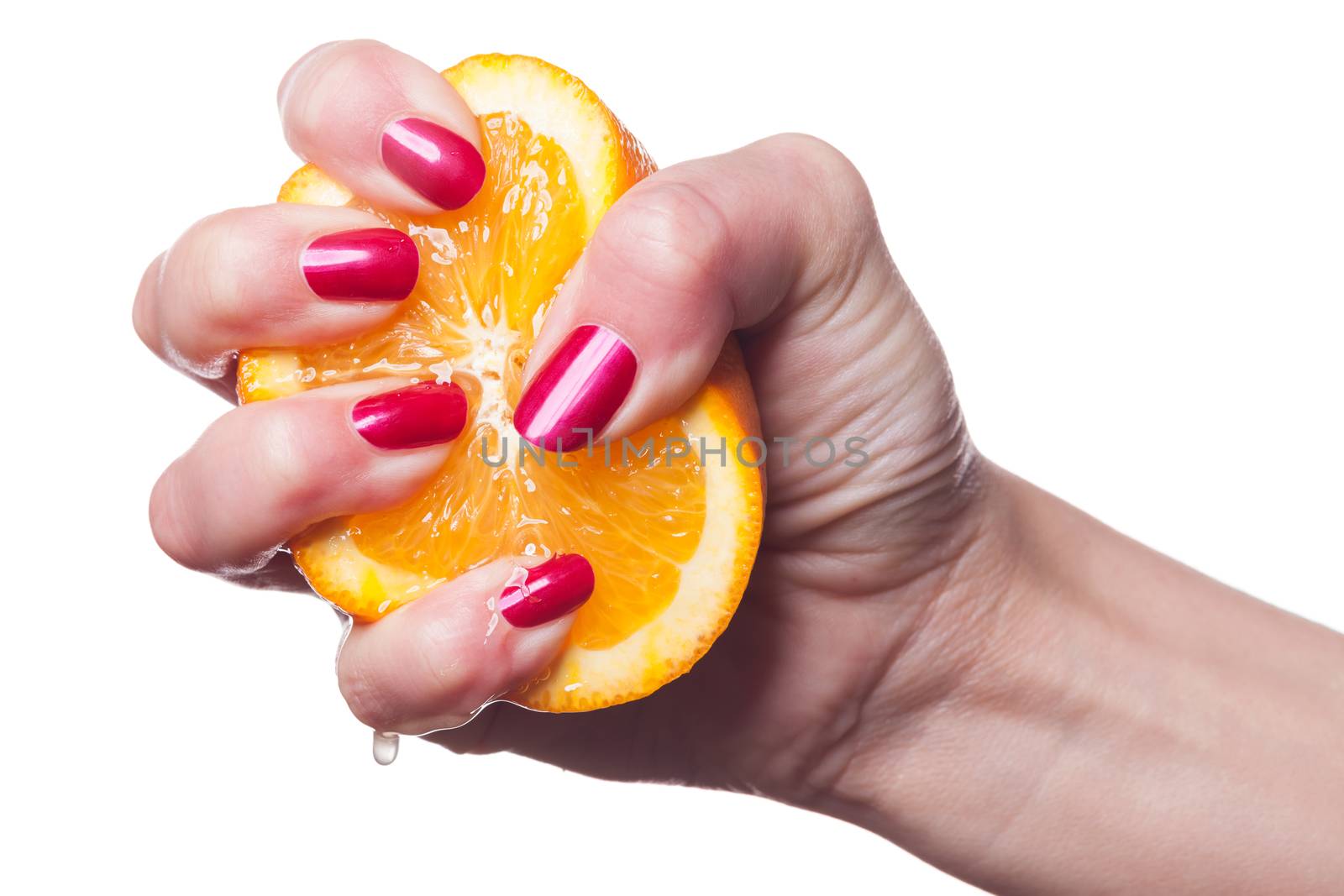 Hand with manicured nails touch an orange on white by juniart