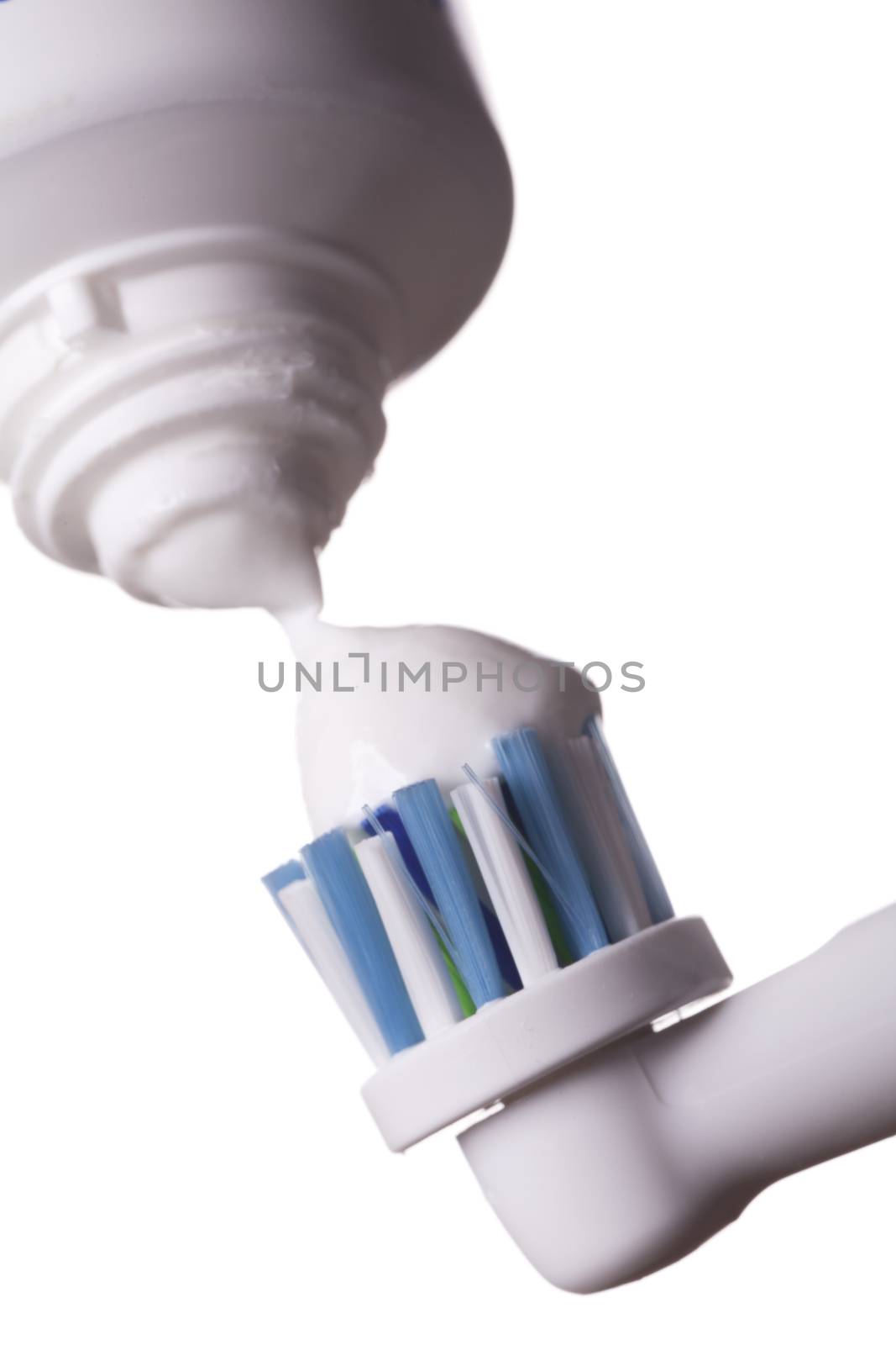Close up of electric toothbrush and paste on white by juniart