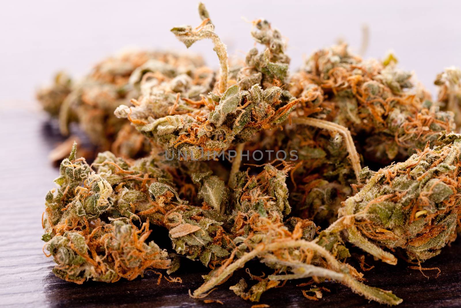 Close up Dried Marijuana Leaves on the Table by juniart
