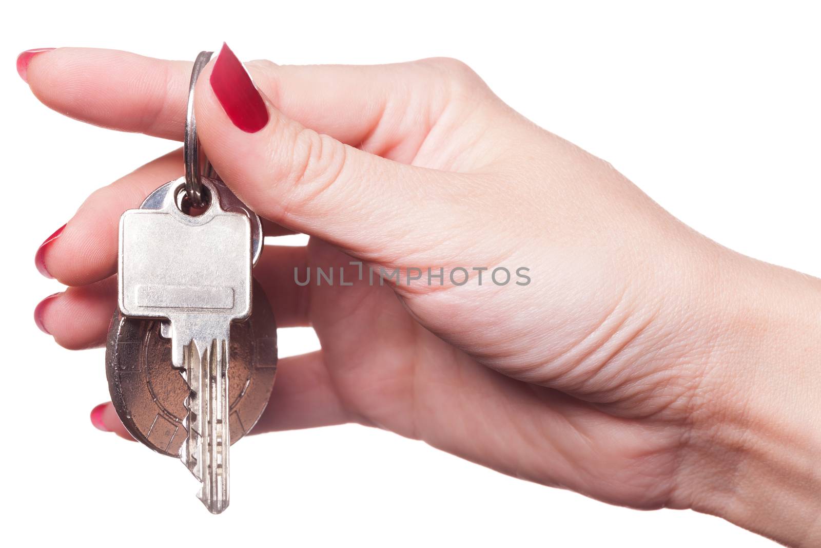 Close up of manicured fingers painted a deep glossy red curling around set of car keys