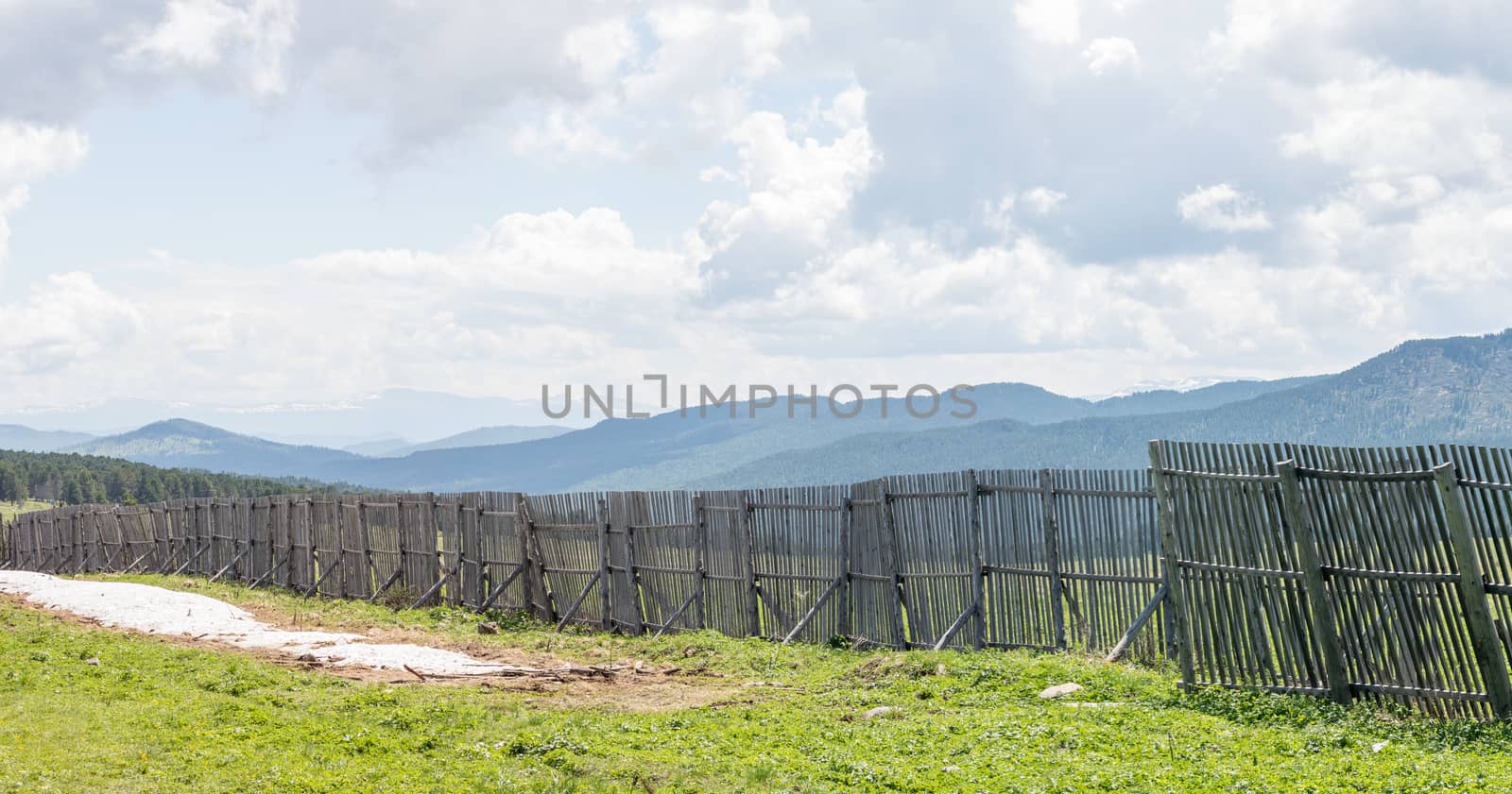 The idyllic landscape: view of the mountains behind the fence from the pass