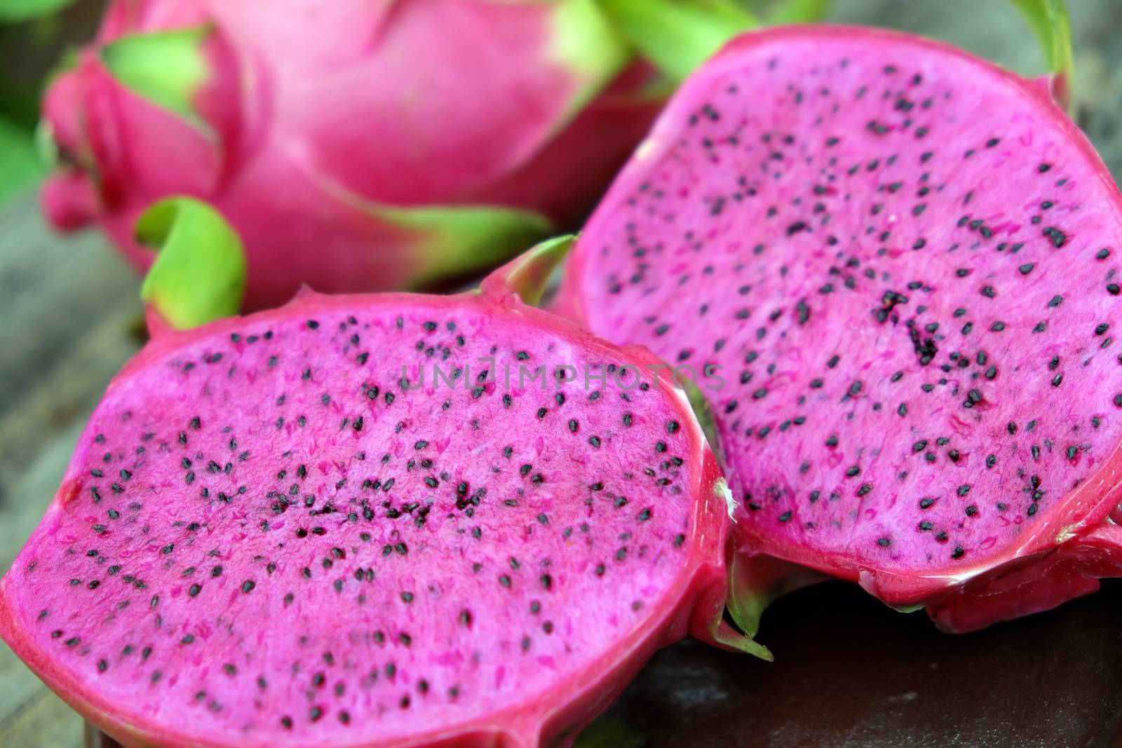 Eating dragon fruit, a tropical fruits, Vietnam agriculture product, with purle, pink color, close up of delicious dessert at garden