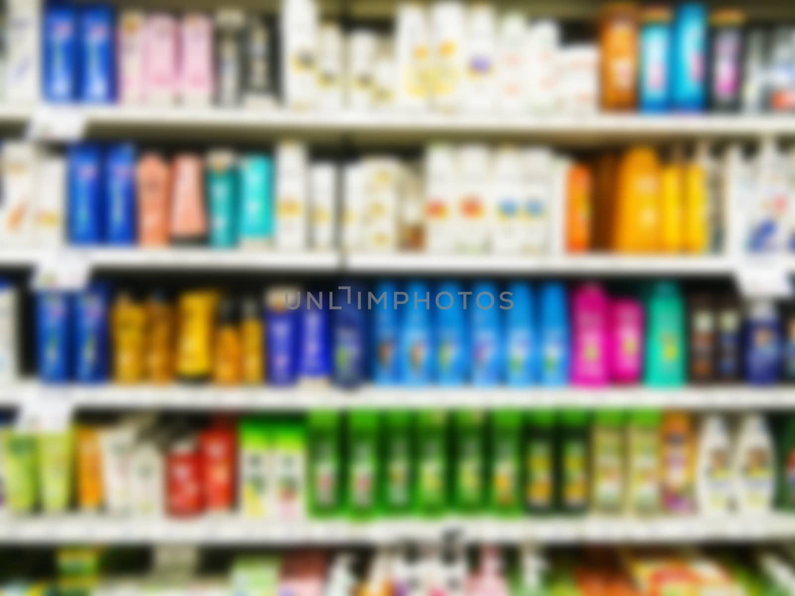 Blurred colorful supermarket products on shelves by fascinadora