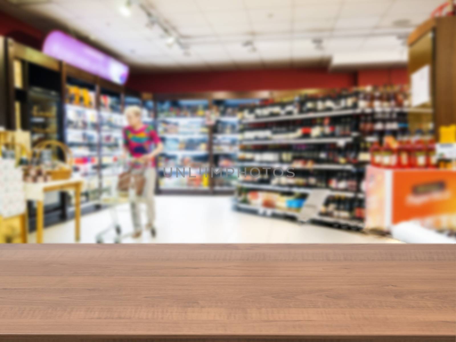 Wooden empty table in front of blurred supermarket by fascinadora