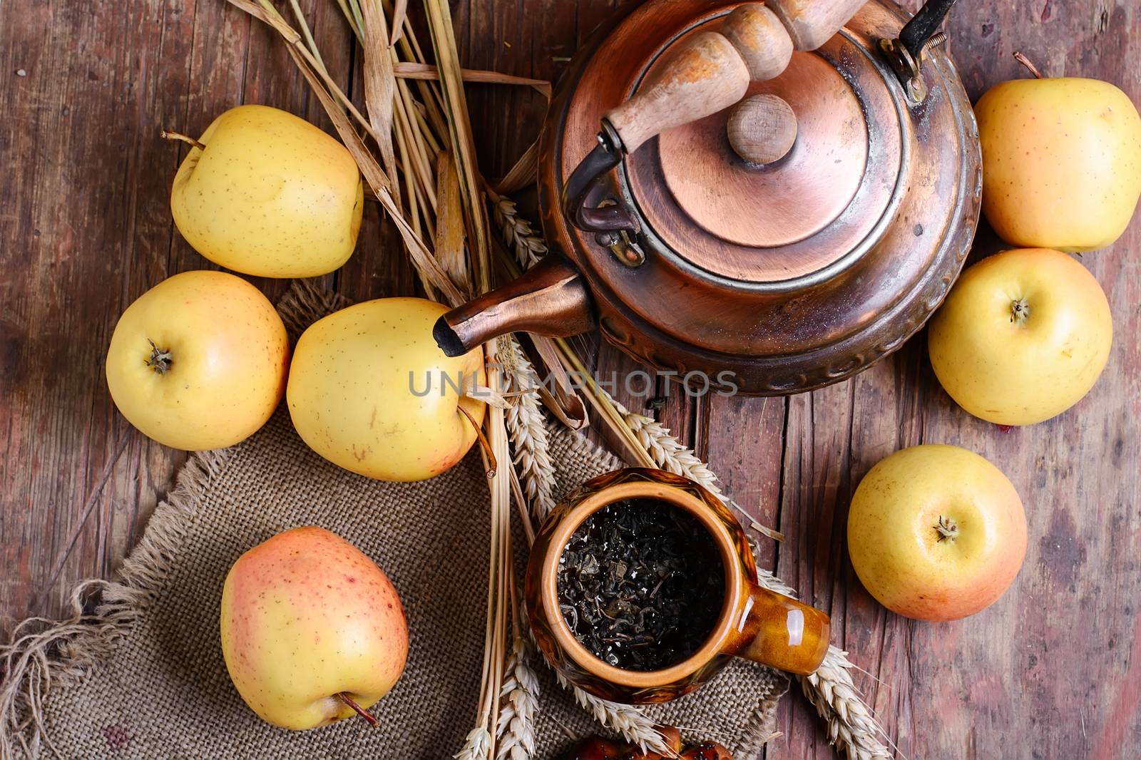 autumn harvest of apples,ears of wheat and kettle