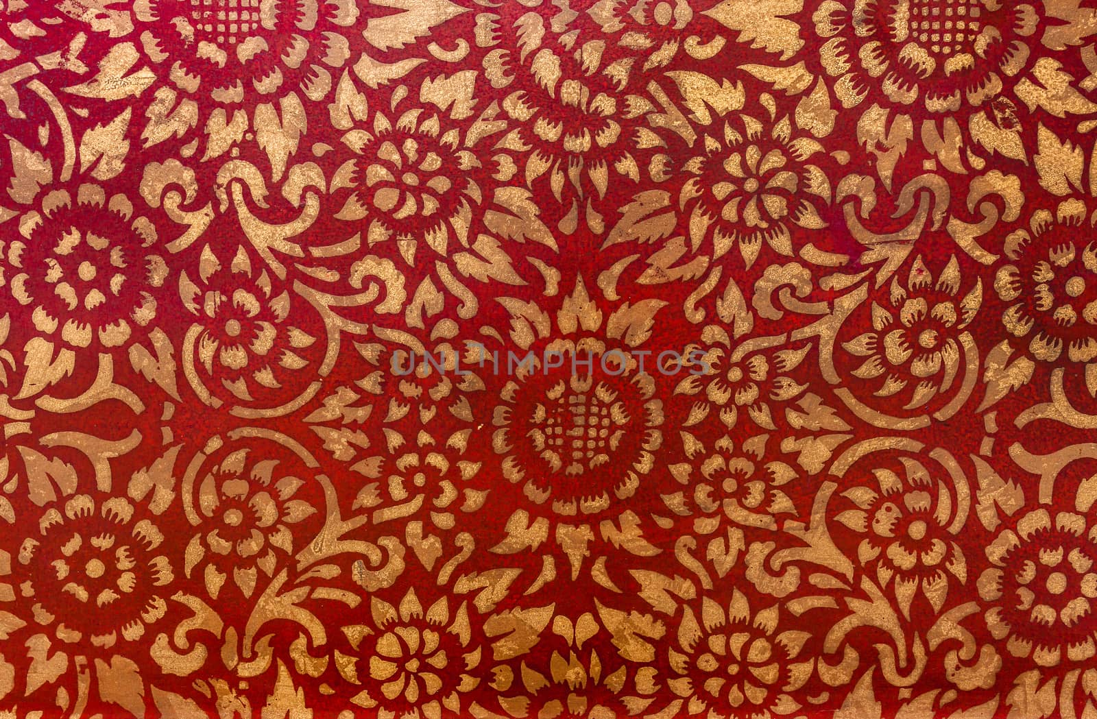 The gold leaf on wood for the background and textures. Thai style pattern on red wall .