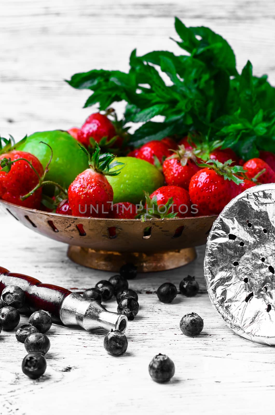 Smoking hookah with taste of fresh strawberries,lime and mint